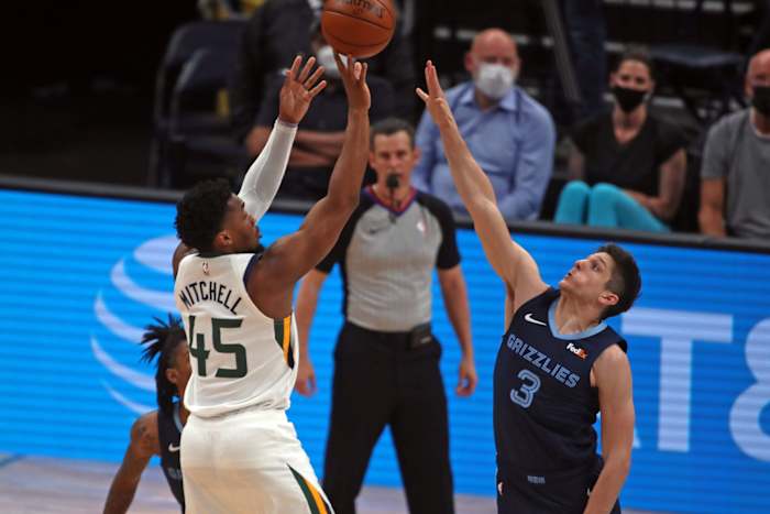 Donovan Mitchell (45) shoots over Grayson Allen (3)